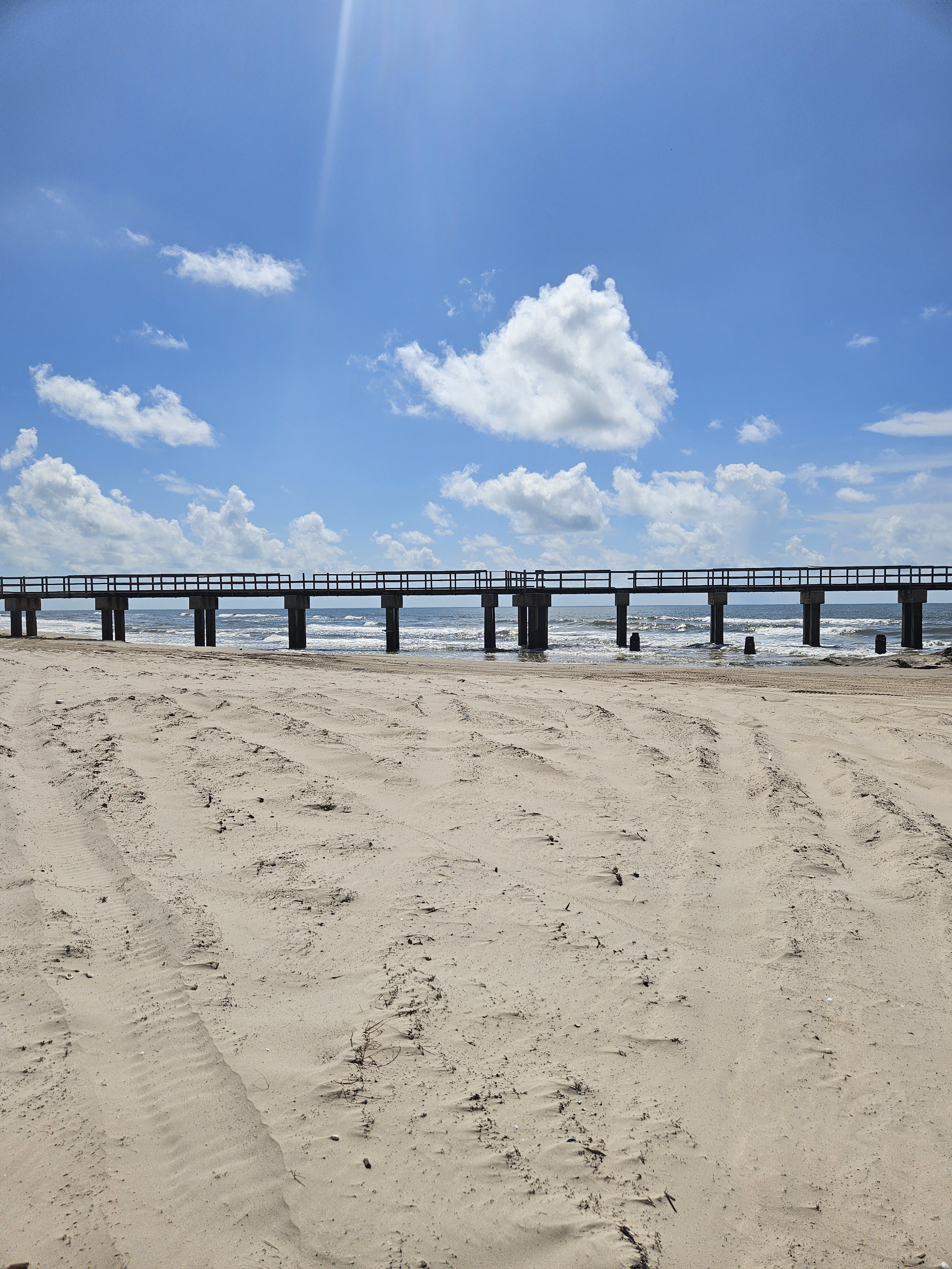 The fishing pier reaching over the surf at Matagorda