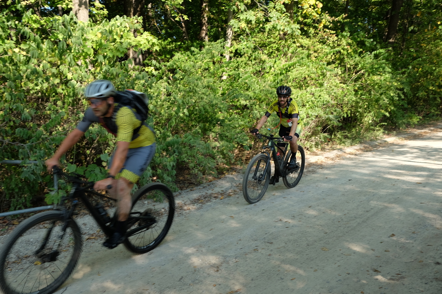 Two Mountain Bike cyclists compete at the Dirty Fox Five Hour Trail Race. Here they are on their bikes as they take the lead over the nearest competitors - blazing fast along the route.
