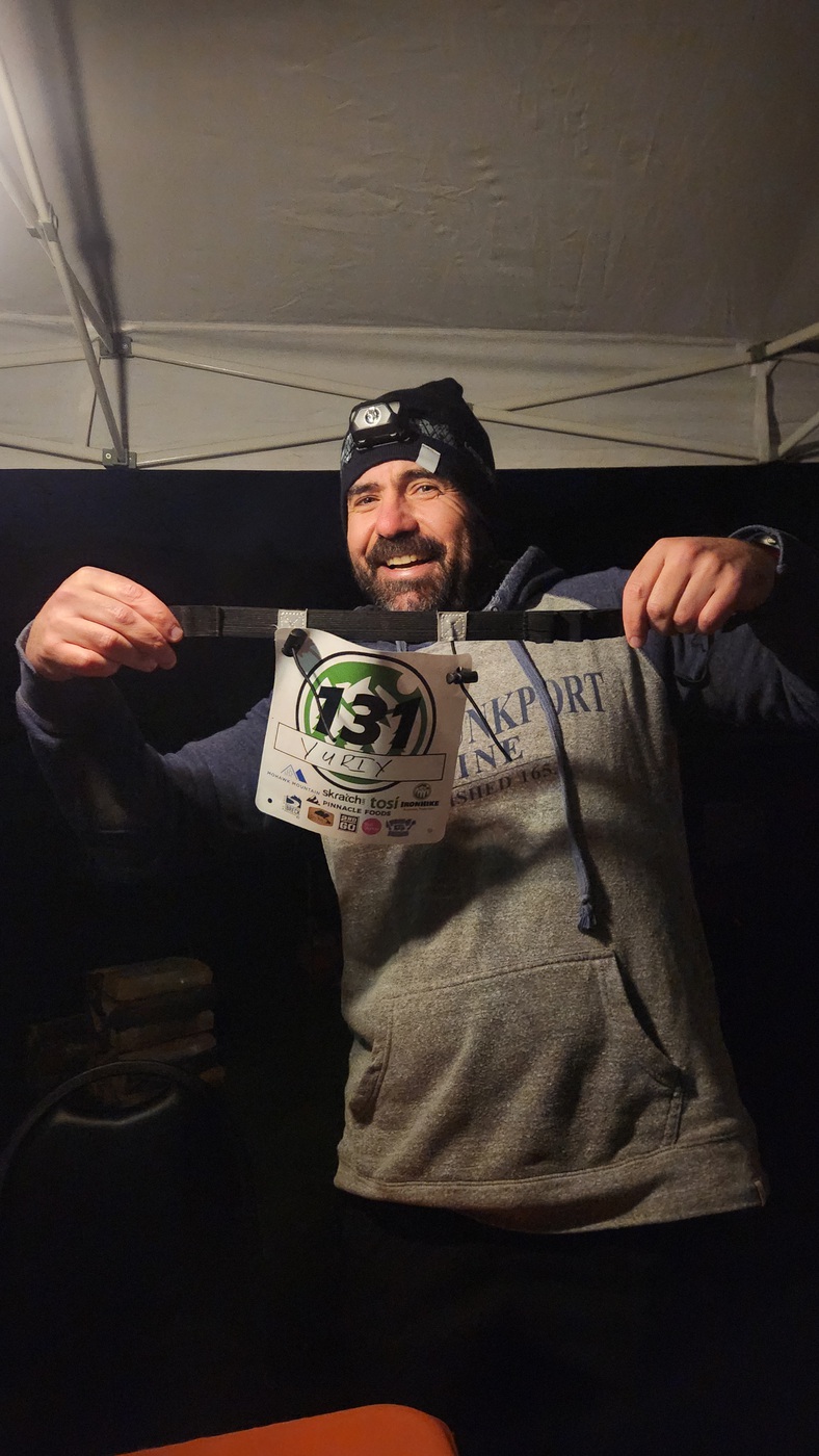 IronHike Mountain Athlete grinning with his bib and headlamp at night check-in, Mohawk Mountain Cornwall CT