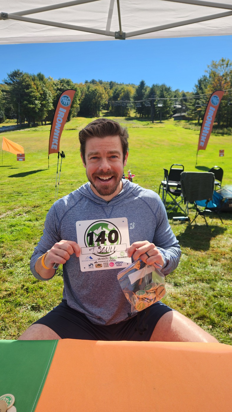 IronHike Mountain Athlete holding his bib and bag of lap tokens at check-in, Mohawk Mountain Cornwall CT