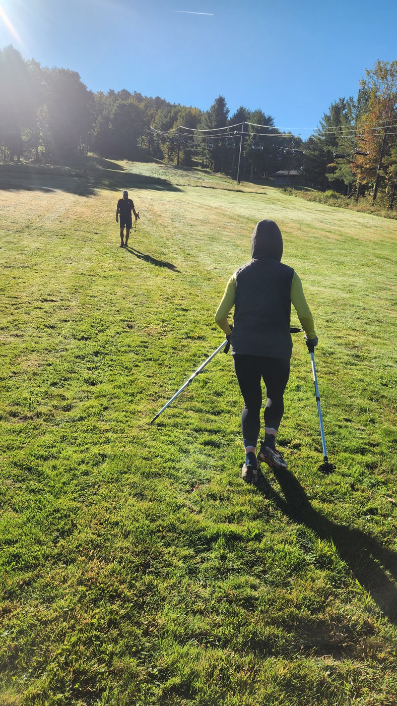IronHike Mountain Athlete with trekking poles heading up the slope in the morning sun, Mohawk Mountain Cornwall CT