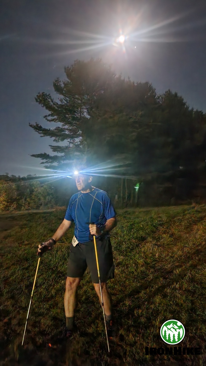 IronHike Mountain Athlete trekking by headlamp under the moon with trekking poles, IronHike Everest endurance Event Mohawk Mountain Cornwall CT